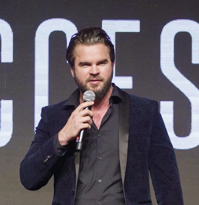 James Warwick speaking on stage